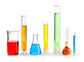 Laboratory glassware with colorful liquids on white background Royalty Free Stock Photo