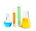 Laboratory glassware with colorful liquids on white background Royalty Free Stock Photo