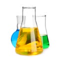 Laboratory glassware with colorful liquids on white background Royalty Free Stock Photo