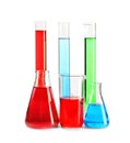 Laboratory glassware with colorful liquids on white background Royalty Free Stock Photo