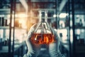 Laboratory glassware containing chemical liquid, science research and development concept, hand of scientist holding flask with Royalty Free Stock Photo