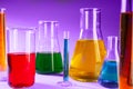 Laboratory glassware with different liquids on color background Royalty Free Stock Photo