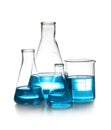 Laboratory glassware with liquid on table against white background Royalty Free Stock Photo