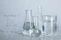 Laboratory glassware with liquids for analysis on table and chemical formulas Royalty Free Stock Photo