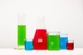 Laboratory glassware with liquids of different colors on table. Royalty Free Stock Photo