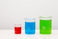 Laboratory glassware with liquids of different colors on table. Royalty Free Stock Photo