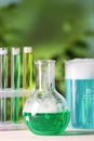 Laboratory glassware and test tubes with colorful liquids on white table. Chemical reaction Royalty Free Stock Photo