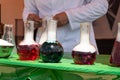 Laboratory glassware and test tubes with liquids on glass table outdoors. Chemical reaction Royalty Free Stock Photo