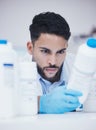 Laboratory, man or scientist reading container to check medical stock or information on cure. Research study, bottle Royalty Free Stock Photo