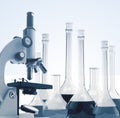 Laboratory metal microscope and test tubes with liquid toning