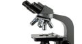 Laboratory microscope featuring multiple objective lenses, a rotating turret, and
