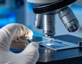 Laboratory Microscope and Scientist Hand Handling Sample Royalty Free Stock Photo