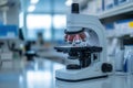 A laboratory microscope prominently sits on a workbench surrounded by equipment in a Royalty Free Stock Photo