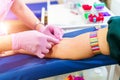 Laboratory with nurse taking blood sample from patient. Background with blood samples in tubes. Royalty Free Stock Photo