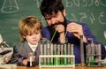 laboratory research and development. bearded man teacher with little boy. Laboratory test tubes and flasks with liquids