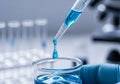A laboratory scene with a gloved hand holding a beaker filled with blue liquid. A pipette is Royalty Free Stock Photo