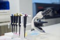 Laboratory scene with pipettes and microscope in a modern research facility Royalty Free Stock Photo