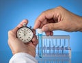 Laboratory Scientist Using Stopwatch and Test Tubes for Experiment Royalty Free Stock Photo