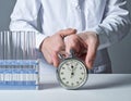 Laboratory Scientist Using Stopwatch and Test Tubes for Experiment Royalty Free Stock Photo