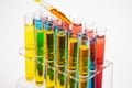 In the laboratory, scientists synthesized and analyzed the compound by dropping colored liquid in test tubes. White background