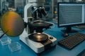 Laboratory setup with microscope examining semiconductor wafer during research on electronics Royalty Free Stock Photo