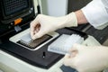 A laboratory specialist places test tubes with test samples in a special apparatus for studying the composition Royalty Free Stock Photo