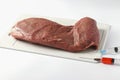 Laboratory studies of raw meat on plastic board on white background. Chemical experiment. Closeup