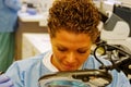 Laboratory technician looking through magnifying glass Royalty Free Stock Photo