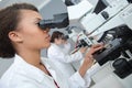 Laboratory technician looking into microscope eyepiece Royalty Free Stock Photo