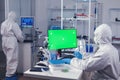 Laboratory technician in medicine lab uses computer with green screen Royalty Free Stock Photo