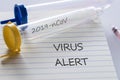 Laboratory vial with `Coronovirus` inscription. Notebook with `Virus Alert` concept, epidemiological threats