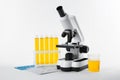 Laboratory ware with urine sample for analysis and microscope on background Royalty Free Stock Photo