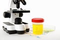 Laboratory ware with urine samples for analysis and microscope on white Royalty Free Stock Photo