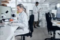 Laboratory woman, microscope or computer typing in cancer research, medical healthcare innovation or insurance medicine Royalty Free Stock Photo