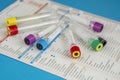 Several tubes for blood samples on test request sheet Royalty Free Stock Photo