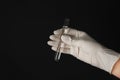 Laboratory worker holding test tube with water on black background Royalty Free Stock Photo