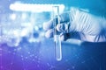 Laboratory worker holding test tube with water on blurred background Royalty Free Stock Photo