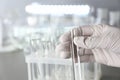 Laboratory worker holding test tube with water near table Royalty Free Stock Photo