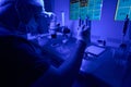 Laboratory worker mixing liquids, preparing nutrients to help embryos grow