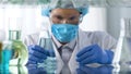 Laboratory worker in special suit preparing reagents for scientific experiments Royalty Free Stock Photo