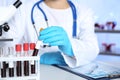Laboratory worker taking test tube with blood sample