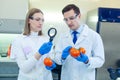 Laboratory workers examining fruits and vegetables and making analysis for pesticides and nitrates.