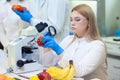 Laboratory workers examining fruits and vegetables and making analysis for pesticides and nitrates.