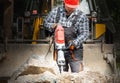 A laborer uses a jackhammer to break up a concrete pavement Royalty Free Stock Photo