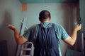 Puzzled Construction Worker Shrugging Looking at Renovation Site Royalty Free Stock Photo