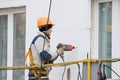 Laborer in helmet at facade works