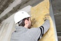 Laborer laying glass wool