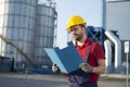 Laborer outside a factory working dressed with safety overalls equipment Royalty Free Stock Photo