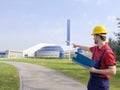 Laborer outside a factory working dressed with safety overalls equipment Royalty Free Stock Photo