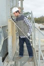 Laborer outside factory working dressed with safety overalls equipment Royalty Free Stock Photo